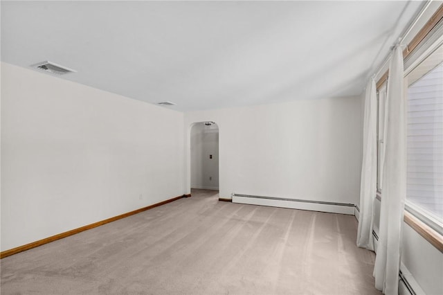 122 Cannon St, Cranston, RI 02920 - empty room with baseboard heating, light colored carpet, and arched walkways