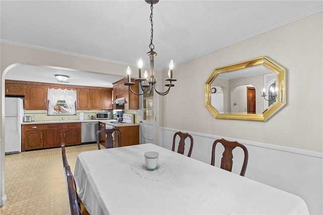 122 Cannon St, Cranston, RI 02920 - dining area with a chandelier, crown molding, and wainscoting