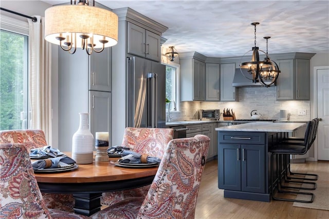 31 Wickaboxet Dr, West Greenwich, RI 02817 - kitchen with a chandelier, high end refrigerator, gray cabinets, exhaust hood, and light wood-style floors