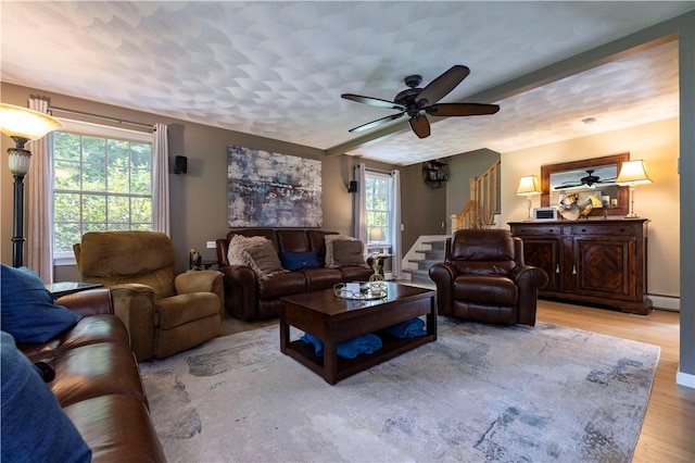 31 Wickaboxet Dr, West Greenwich, RI 02817 - living area with stairs, a baseboard heating unit, a ceiling fan, and wood finished floors