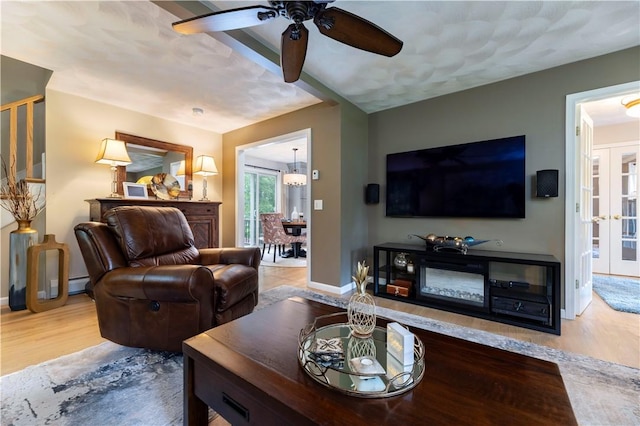 31 Wickaboxet Dr, West Greenwich, RI 02817 - living room with wood finished floors, ceiling fan, a chandelier, and a baseboard radiator
