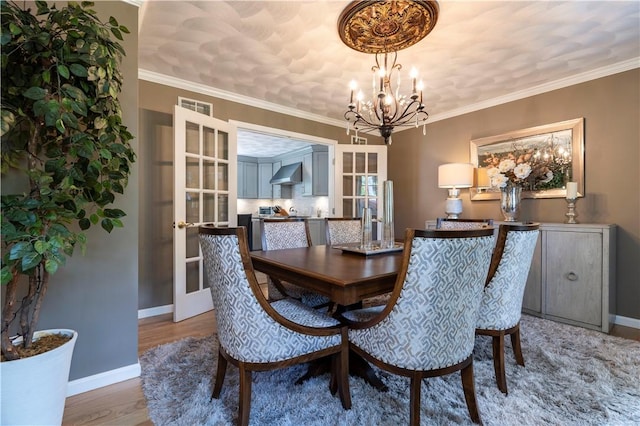 31 Wickaboxet Dr, West Greenwich, RI 02817 - dining area featuring a chandelier, wood finished floors, and french doors
