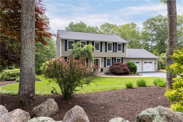 31 Wickaboxet Dr, West Greenwich, RI 02817 - colonial-style house featuring an attached garage, a front lawn, and asphalt driveway
