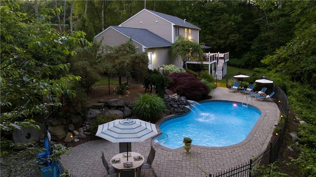 31 Wickaboxet Dr, West Greenwich, RI 02817 - view of swimming pool with stairs, a patio, a wooden deck, and a wooded view