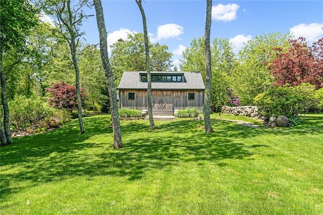 1049 Matunuck Schoolhouse Rd, South Kingstown, RI 02879 - view of front of house with board and batten siding and a front yard