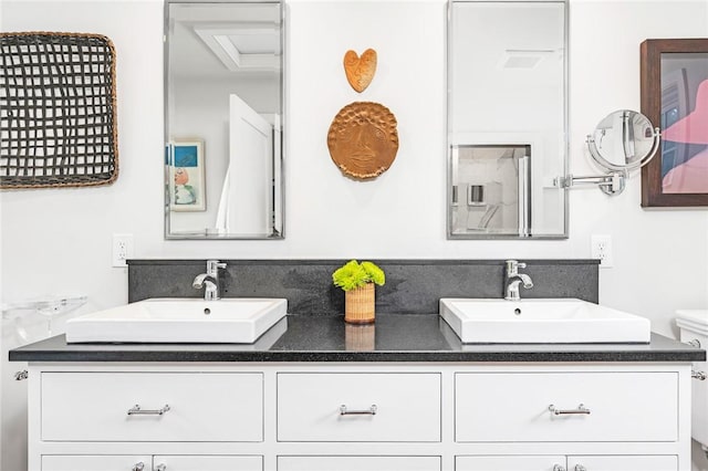 1049 Matunuck Schoolhouse Rd, South Kingstown, RI 02879 - bathroom with double vanity and toilet