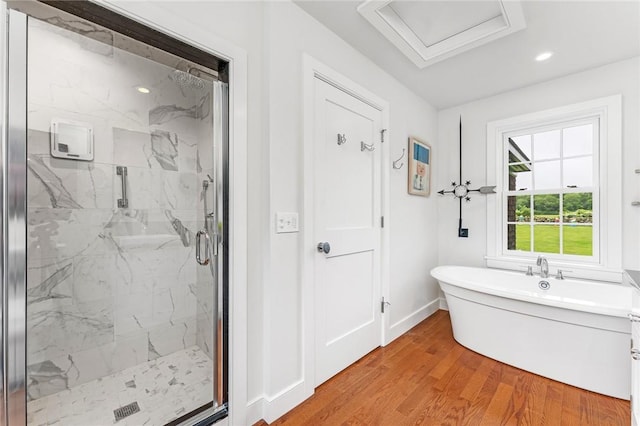 1049 Matunuck Schoolhouse Rd, South Kingstown, RI 02879 - bathroom with a marble finish shower, a soaking tub, wood finished floors, and recessed lighting