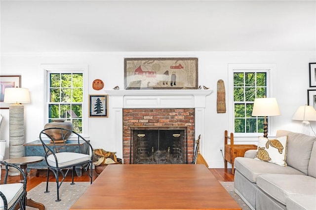 1049 Matunuck Schoolhouse Rd, South Kingstown, RI 02879 - living room featuring wood finished floors, a fireplace, plenty of natural light, and crown molding