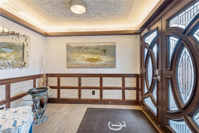 31 Coddington Unit 24, Newport, RI 02840 - entryway featuring a raised ceiling, french doors, light wood finished floors, and a textured ceiling