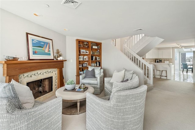 31 Coddington Unit 24, Newport, RI 02840 - living area featuring a fireplace, stairway, and carpet