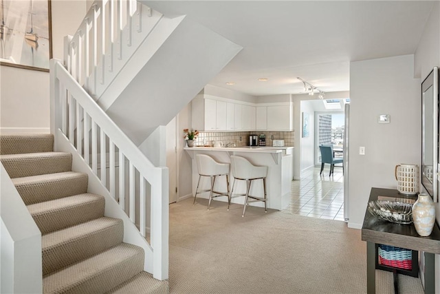31 Coddington Unit 24, Newport, RI 02840 - stairs featuring carpet flooring, rail lighting, and tile patterned floors