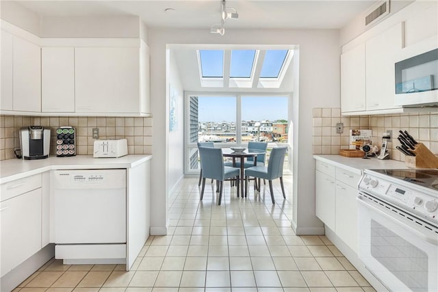 31 Coddington Unit 24, Newport, RI 02840 - kitchen featuring white appliances, light countertops, and decorative backsplash