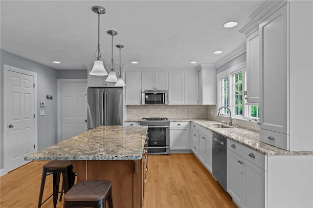 6 Jasons Grant Dr, Cumberland, RI 02864 - kitchen with stainless steel appliances, light wood-style flooring, a kitchen bar, a center island, and recessed lighting