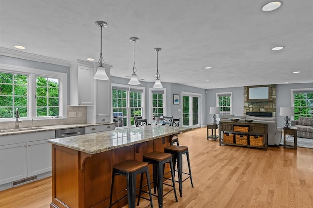 6 Jasons Grant Dr, Cumberland, RI 02864 - kitchen featuring recessed lighting, white cabinetry, light stone counters, a center island, and light wood-type flooring