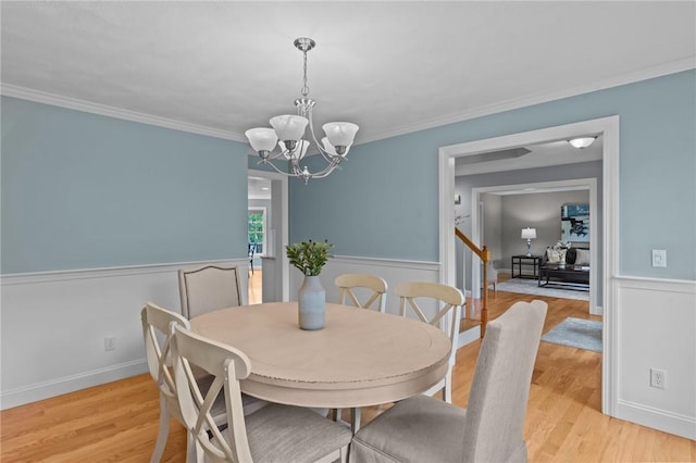 6 Jasons Grant Dr, Cumberland, RI 02864 - dining room with a chandelier, a wainscoted wall, light wood-type flooring, crown molding, and stairs