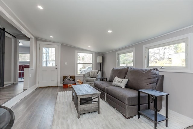 56 Park Ln, Coventry, RI 02816 - living area with light wood-style flooring, a barn door, vaulted ceiling, and recessed lighting