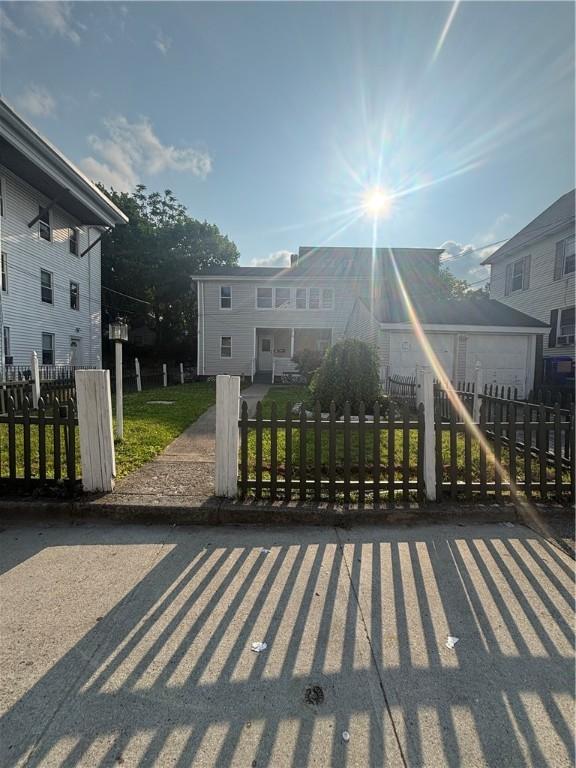 34 Lewis St, Central Falls, RI 02863 - view of front of house with a fenced front yard