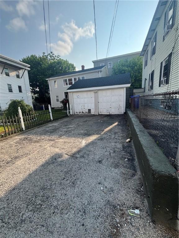 34 Lewis St, Central Falls, RI 02863 - rear view of property with an outdoor structure and a garage