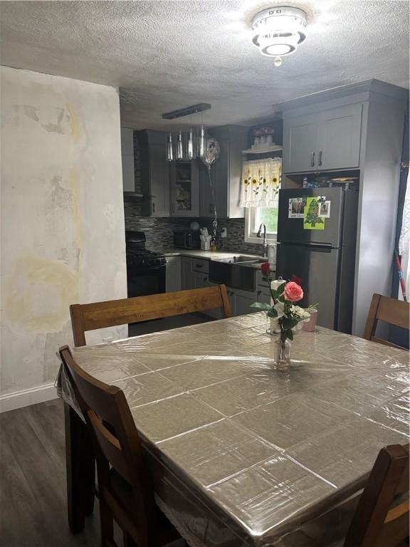 34 Lewis St, Central Falls, RI 02863 - dining space with dark wood finished floors and a textured ceiling