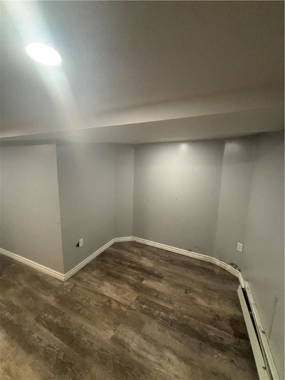 34 Lewis St, Central Falls, RI 02863 - finished below grade area featuring a baseboard radiator and dark wood-style flooring