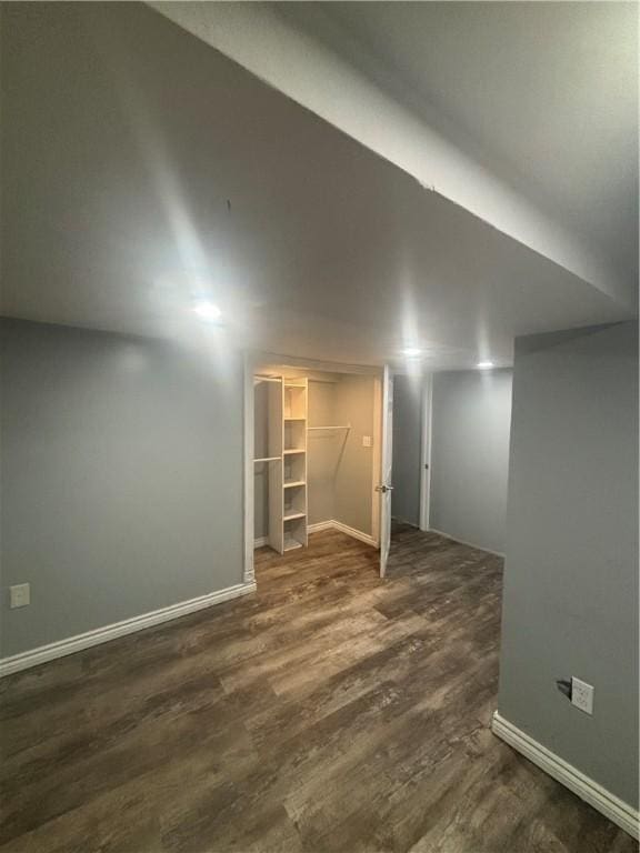 34 Lewis St, Central Falls, RI 02863 - finished basement with dark wood-style flooring and baseboards