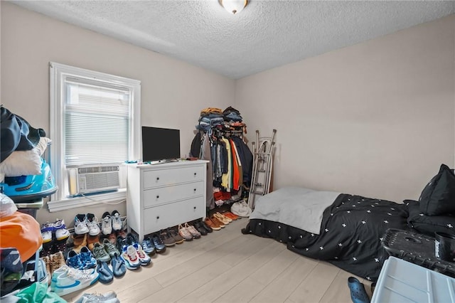 76 Slater St, Pawtucket, RI 02860 - bedroom featuring wood finished floors and a textured ceiling
