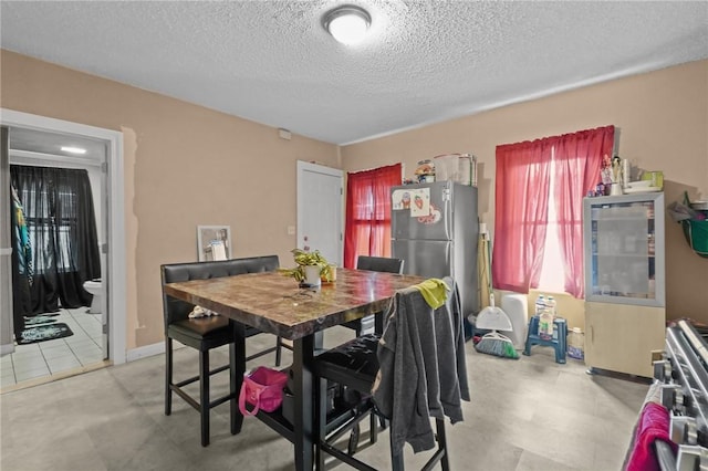 76 Slater St, Pawtucket, RI 02860 - dining room featuring a textured ceiling and baseboards