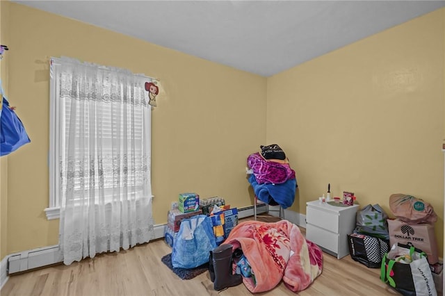 76 Slater St, Pawtucket, RI 02860 - rec room with wood finished floors and a baseboard radiator
