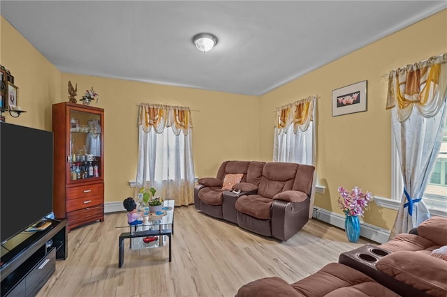76 Slater St, Pawtucket, RI 02860 - living area with light wood-style flooring and a baseboard radiator