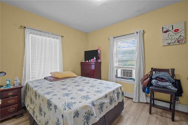76 Slater St, Pawtucket, RI 02860 - bedroom featuring light wood finished floors, cooling unit, and a baseboard heating unit