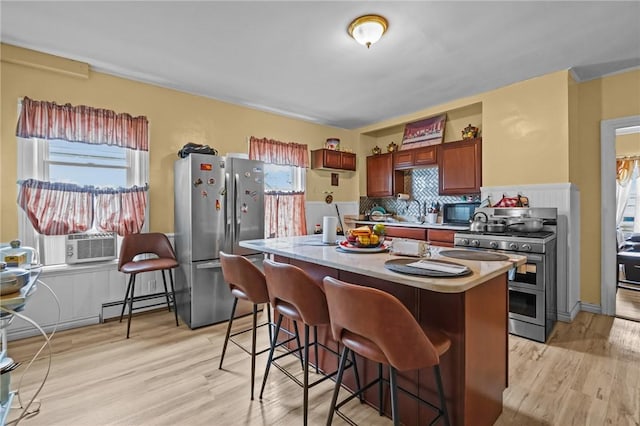 76 Slater St, Pawtucket, RI 02860 - kitchen featuring stainless steel appliances, a baseboard heating unit, cooling unit, and plenty of natural light