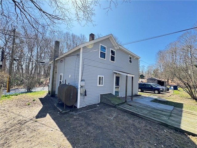 965 Main St, Hopkinton, RI 02832 - back of house featuring a chimney, oil tank, and a wooden deck