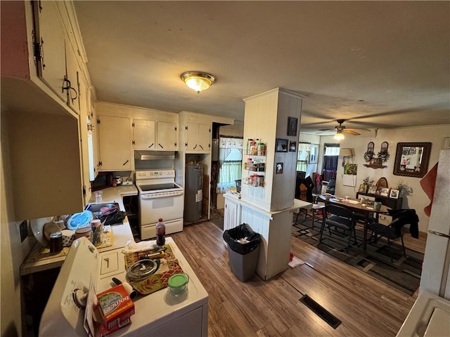 965 Main St, Hopkinton, RI 02832 - kitchen with white electric range oven, a ceiling fan, wood finished floors, light countertops, and under cabinet range hood