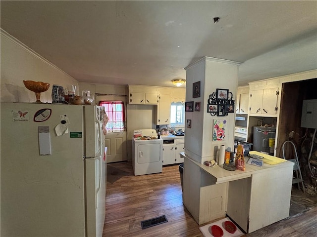 965 Main St, Hopkinton, RI 02832 - kitchen featuring freestanding refrigerator, washer / dryer, electric water heater, dark wood-style floors, and light countertops
