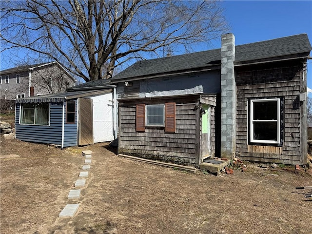 965 Main St, Hopkinton, RI 02832 - rear view of house featuring a shingled roof and a chimney