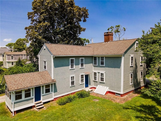 34 Pleasant St, North Kingstown, RI 02852 - rear view of house featuring a chimney, entry steps, a yard, and roof with shingles