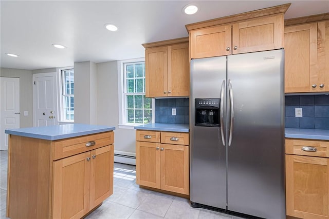 34 Pleasant St, North Kingstown, RI 02852 - kitchen with stainless steel refrigerator with ice dispenser, a baseboard heating unit, light tile patterned floors, backsplash, and light countertops