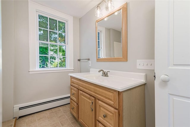 34 Pleasant St, North Kingstown, RI 02852 - bathroom featuring baseboard heating, plenty of natural light, vanity, and tile patterned flooring