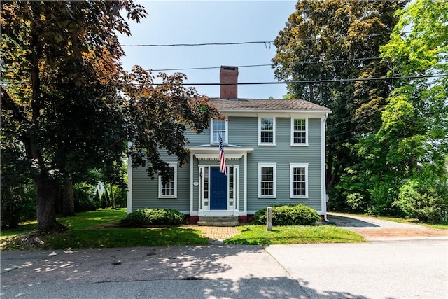 34 Pleasant St, North Kingstown, RI 02852 - view of front facade featuring a chimney and driveway