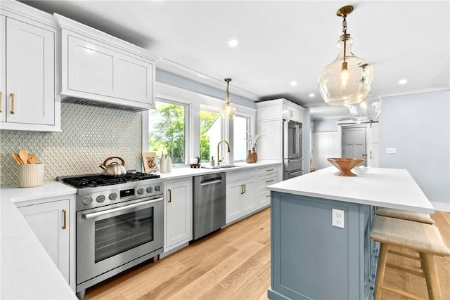 420 Long Hwy, Little Compton, RI 02837 - kitchen featuring appliances with stainless steel finishes, white cabinetry, light wood-style flooring, backsplash, and light countertops