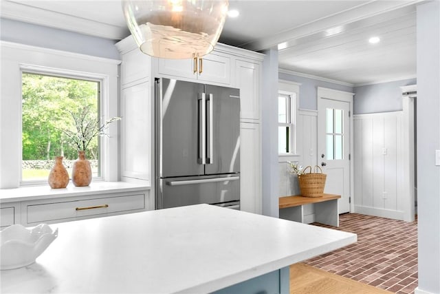 420 Long Hwy, Little Compton, RI 02837 - kitchen with freestanding refrigerator, light countertops, brick patterned flooring, white cabinets, and crown molding