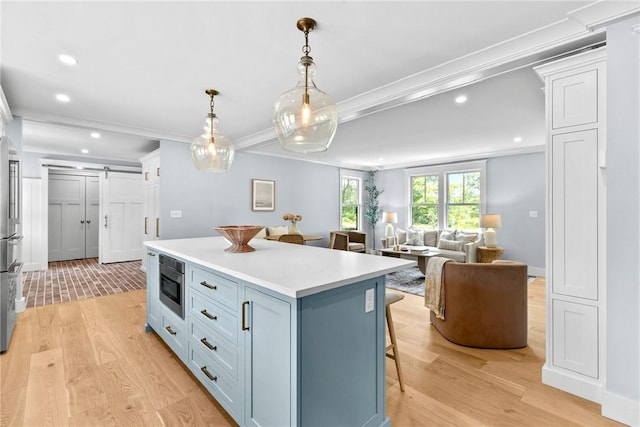 420 Long Hwy, Little Compton, RI 02837 - kitchen with recessed lighting, a breakfast bar, light countertops, light wood-style flooring, and a center island
