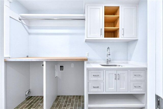 420 Long Hwy, Little Compton, RI 02837 - laundry area featuring cabinet space, hookup for a washing machine, and brick patterned flooring