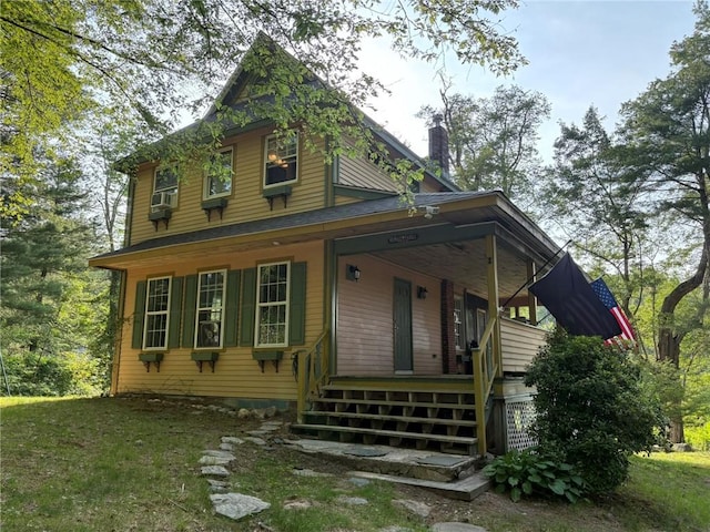 40 Anthony Rd, Foster, RI 02825 - view of front of property featuring covered porch, a chimney, stairway, and cooling unit