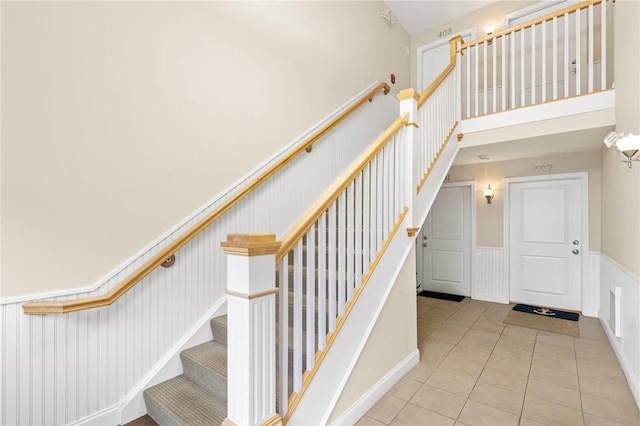 20 Narragansett Ave Unit 404, Narragansett, RI 02882 - stairway with wainscoting, tile patterned floors, and a decorative wall
