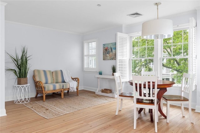 20 Narragansett Ave Unit 404, Narragansett, RI 02882 - dining area with light wood-style flooring and crown molding