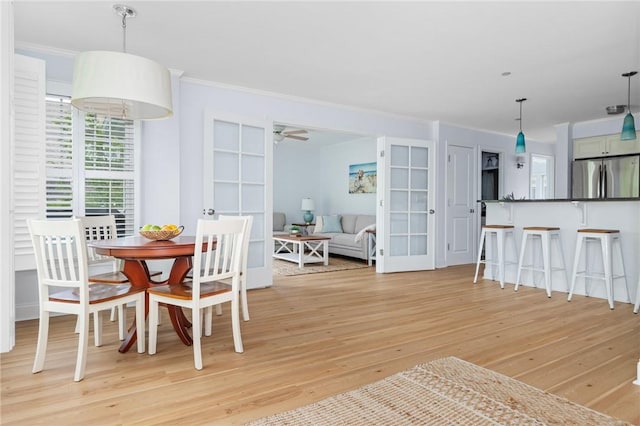 20 Narragansett Ave Unit 404, Narragansett, RI 02882 - dining space with light wood-style flooring, crown molding, french doors, and ceiling fan