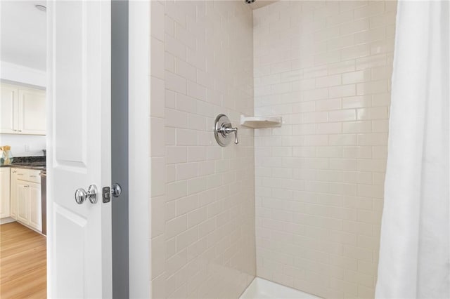 20 Narragansett Ave Unit 404, Narragansett, RI 02882 - bathroom featuring tiled shower, ornamental molding, and wood finished floors