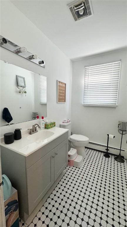 179 Wallace St, Providence, RI 02909 - bathroom with vanity and a baseboard heating unit