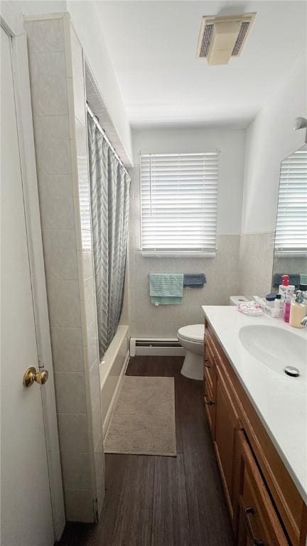 179 Wallace St, Providence, RI 02909 - bathroom featuring a baseboard radiator, vanity, wood finished floors, and shower / tub combo